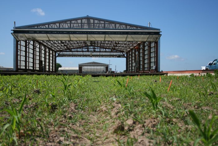 The Drought Simulator, created by Ph.D. candidate Shannon King, acts as a giant mobile greenhouse. Whenever inclement weather moves in, the greenhouse moves on top of the crop field to protect it from any precipitation. Photo by MJ Rogers, Roots in Drought Project